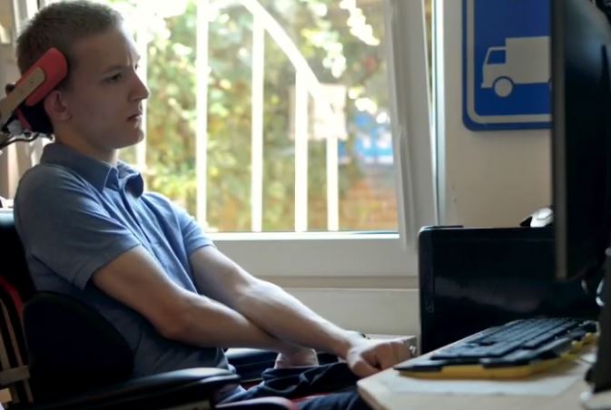 disabled person on a computer reading through a website